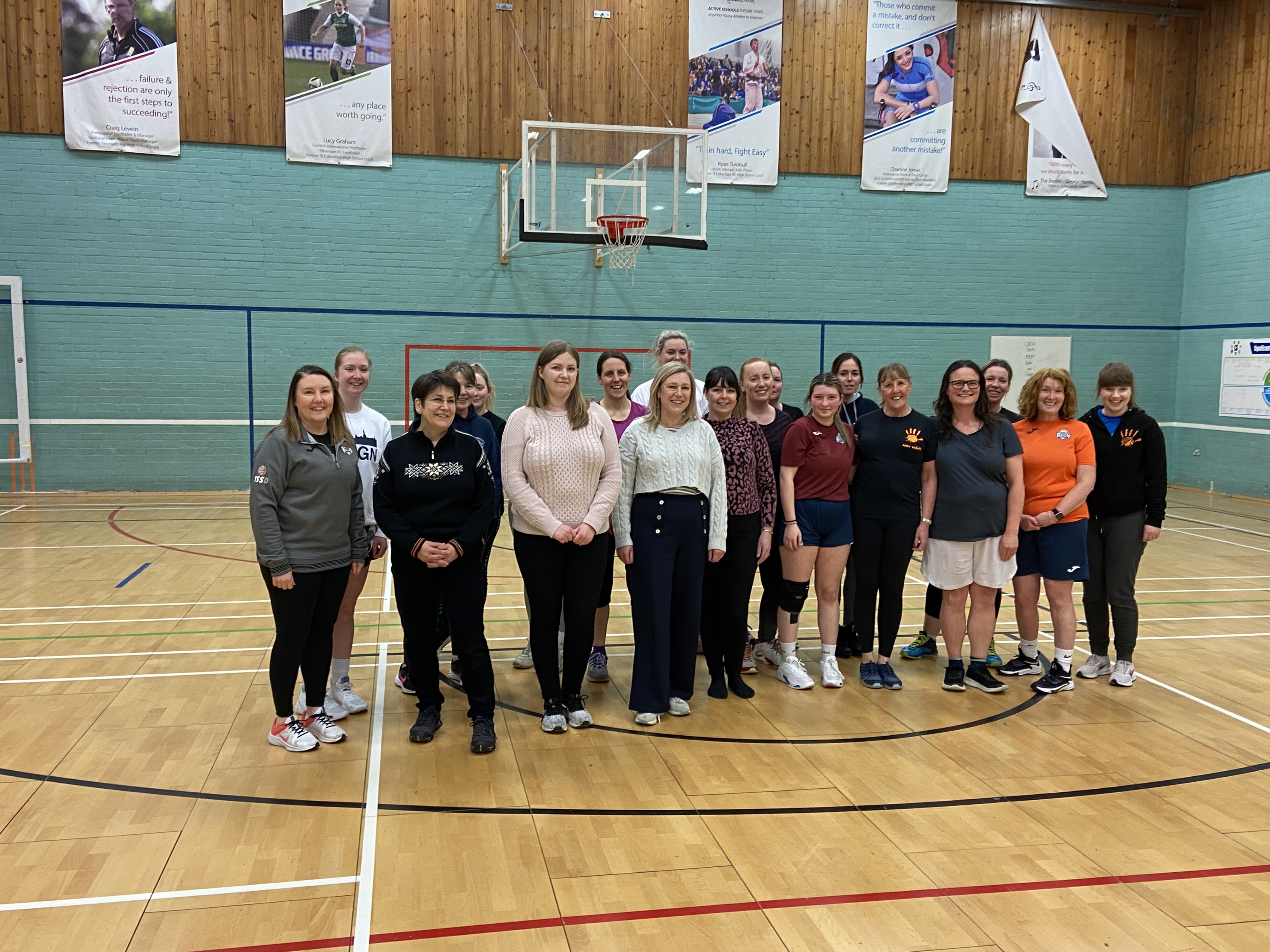 A photograph of Committee Members with members of the Dunfermline Reign Basketball Club